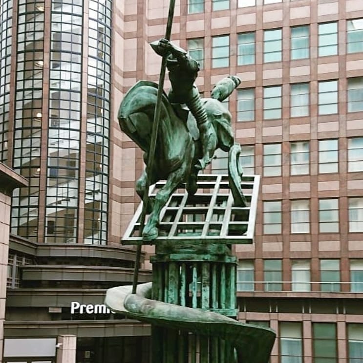 Man on horse attacking a harmless dragon